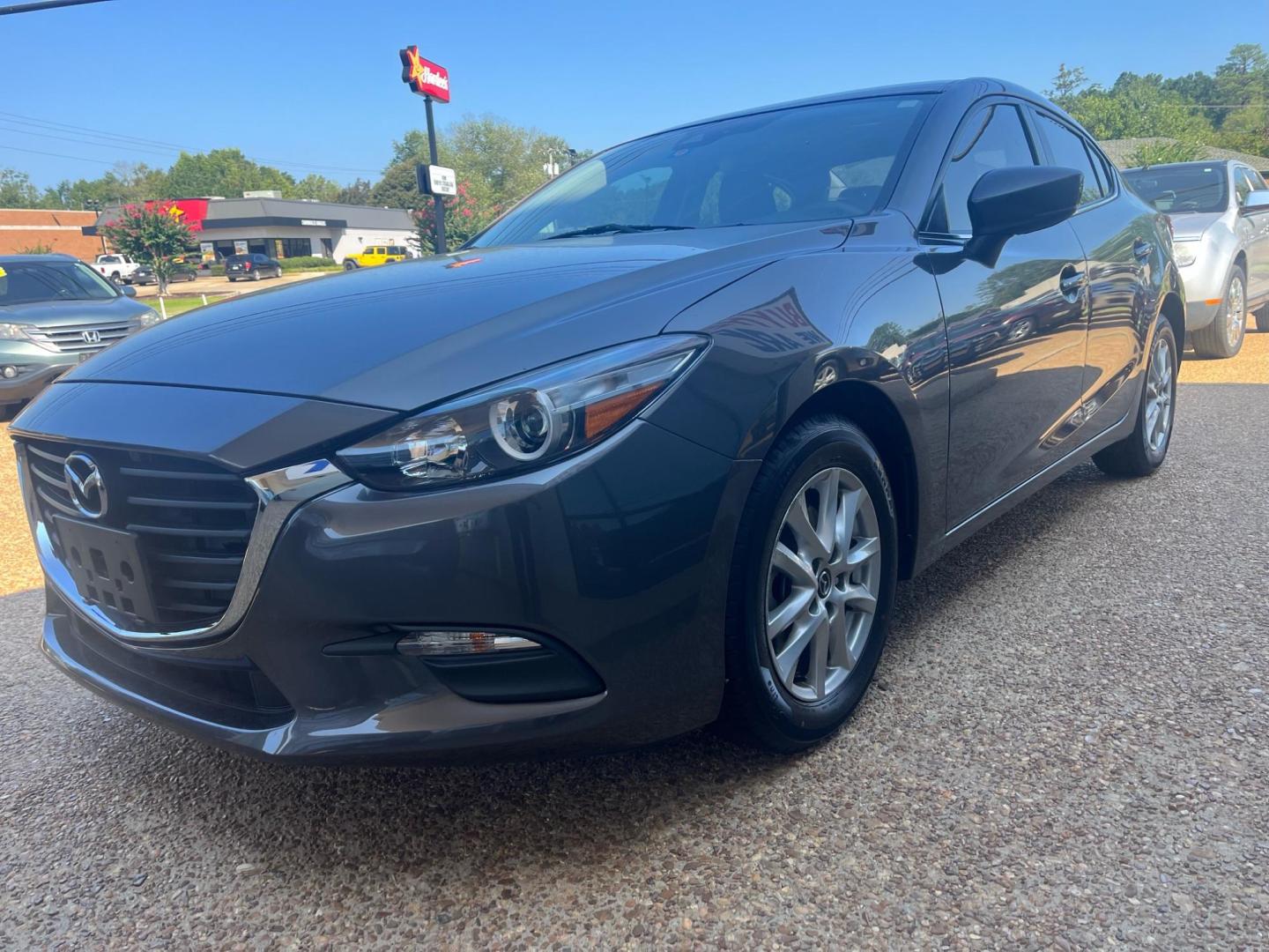 2018 GRAY /Black MAZDA MAZDA3 SPORT Sport (3MZBN1U77JM) with an 2.0L L4 DOHC 16V engine, 6-Speed Automatic transmission, located at 922 W. Beacon St., Philadelphia, MS, 39350, (601) 650-3675, 32.770447, -89.127151 - Title: 2018 Mazda 3 I Sport Year: 2018 Make: Mazda Model: 3 I Sport Engine:2.0L L4 DOHC 16V Body: SEDAN Transmission: 6 Speed Automatic Drive Type: FWD Trim: I Sport MT - Photo#1